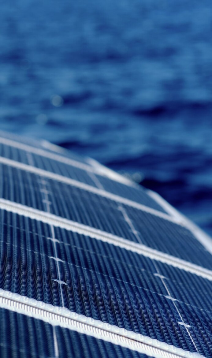 Solar panels and blurred sea background Green renewable energy-min